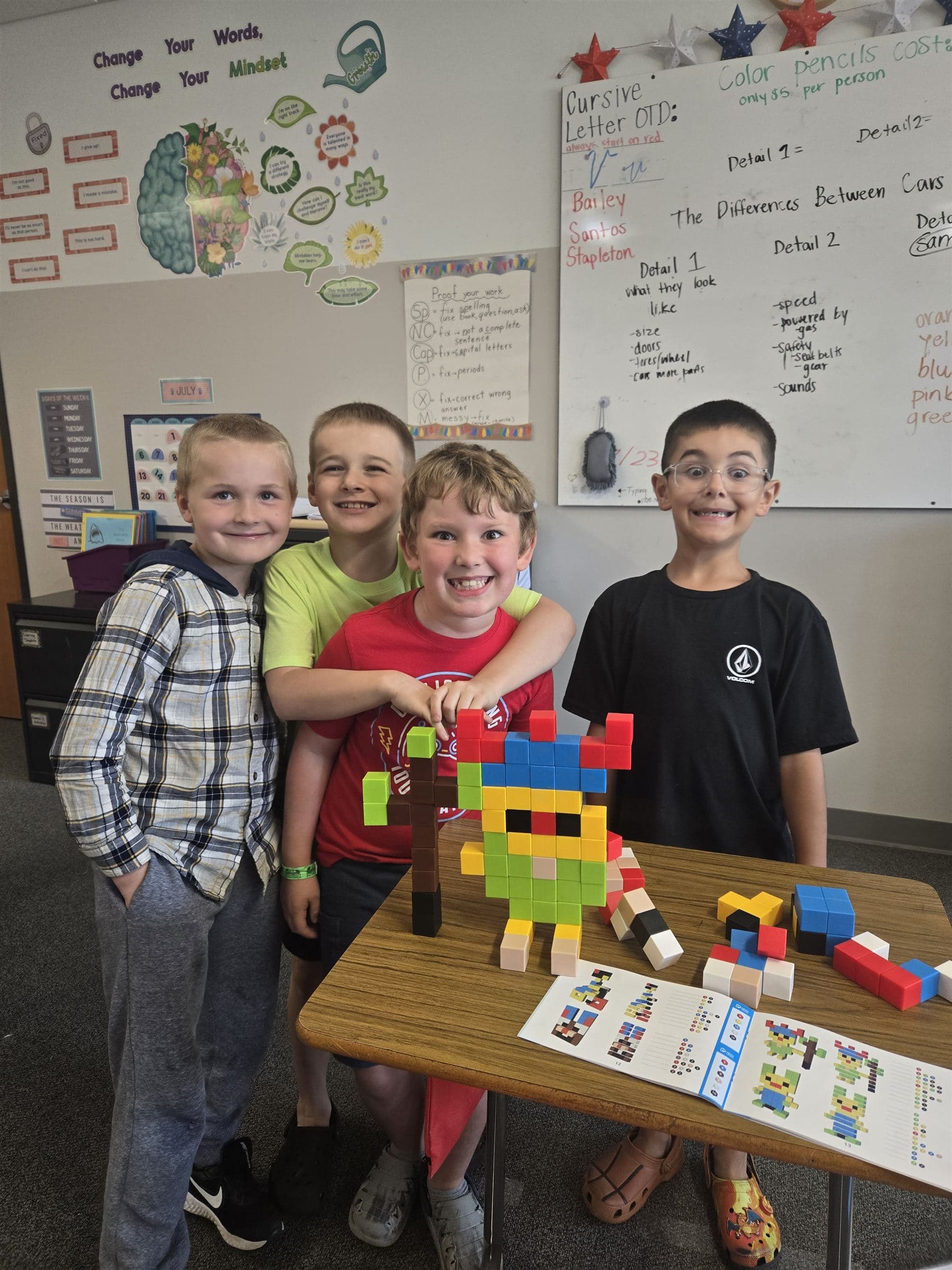 Elementary students proudly showing a project they built together